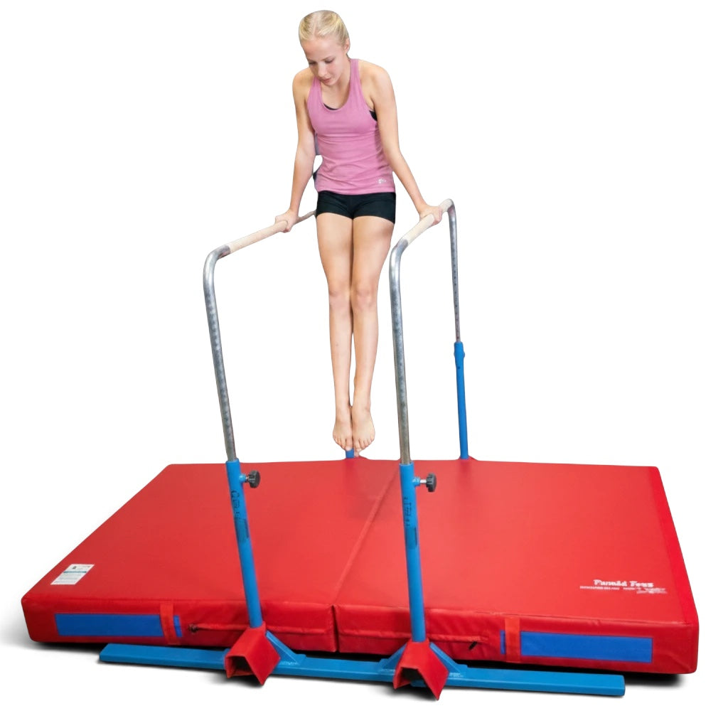 UK Gym Pits 5 in 1 bar system with a red practice mat, featuring a gymnast performing a dip on parallel bars.