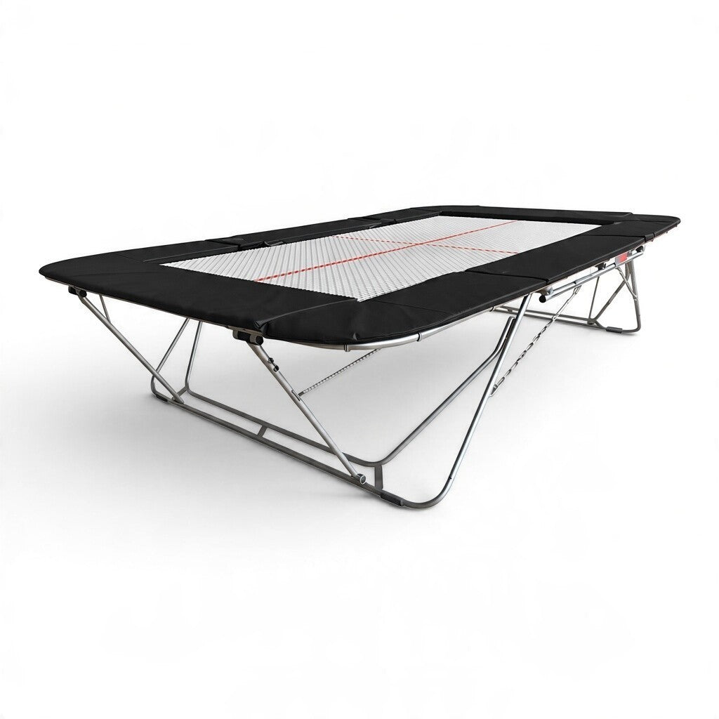 UK Gym Pits 77a standard competition trampoline with a 25mm white web bed and black protective frame pads.