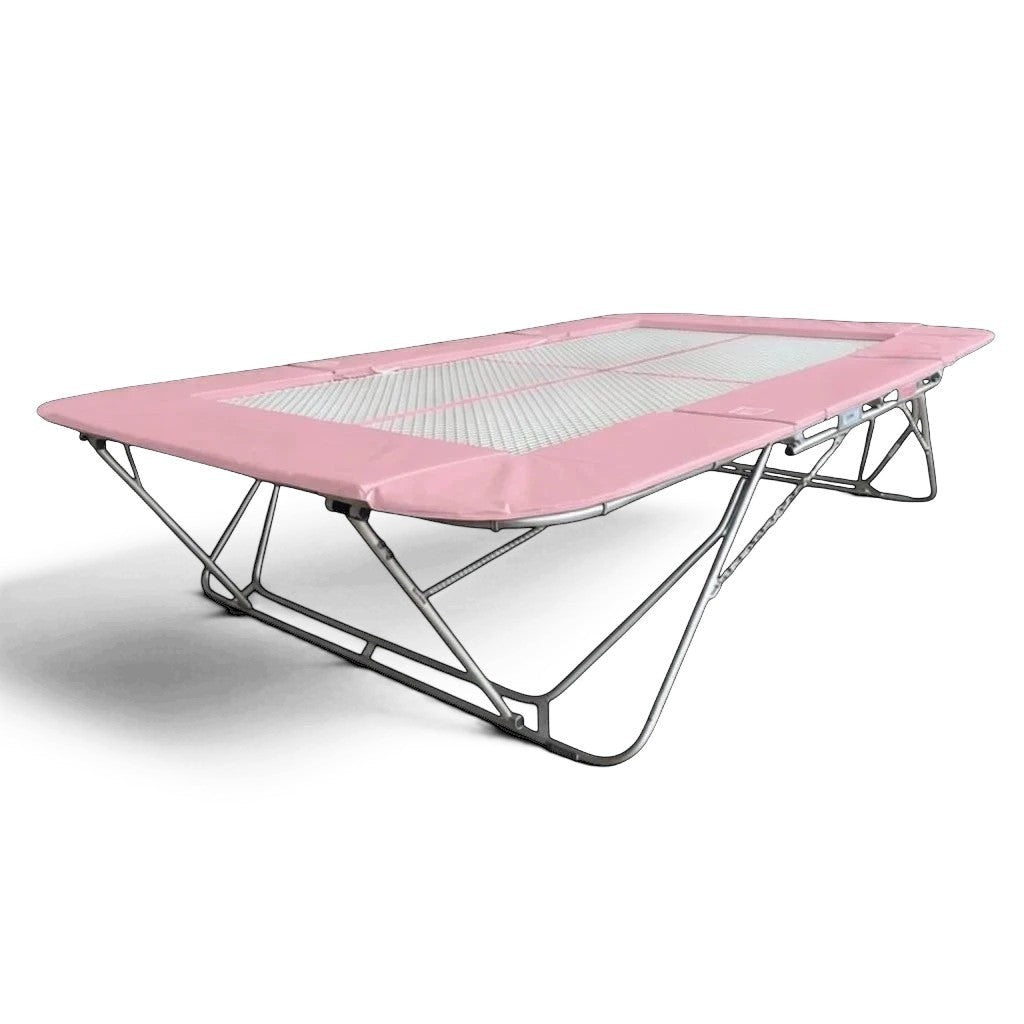 UK Gym Pits 77a standard trampoline with a white super-mesh bed and pink protective frame pads on a steel frame.