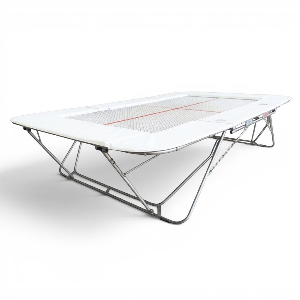 UK Gym Pits 77a standard competition trampoline with a 25mm web bed and white protective frame pads
