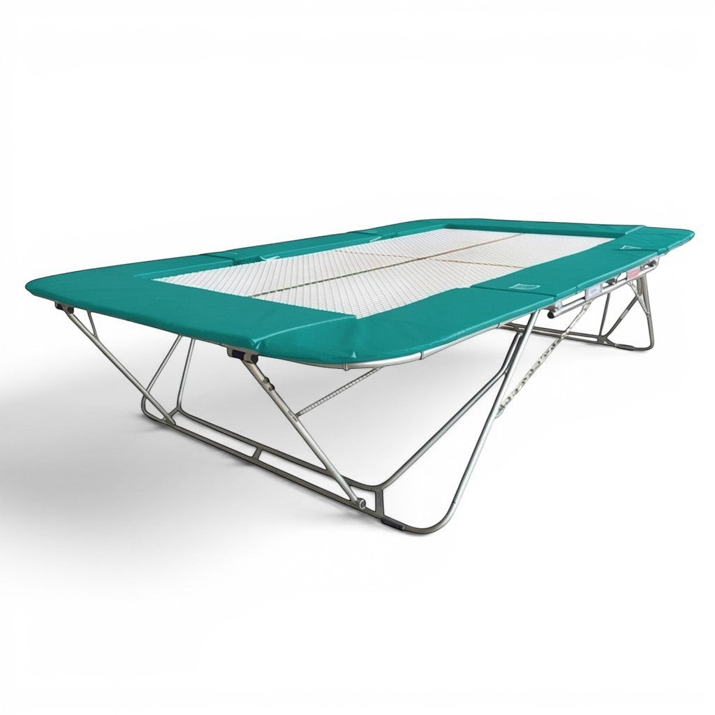 UK Gym Pits 77a standard competition trampoline with a 25mm web bed and teal protective frame pads