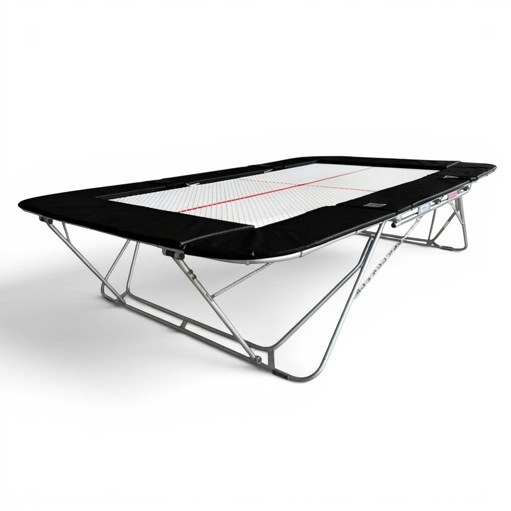 UK Gym Pits 77a standard competition trampoline with a white 25mm web bed and black protective frame pads