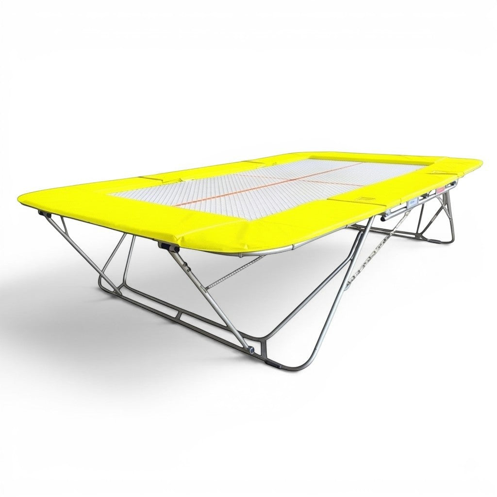UK Gym Pits 77a standard trampoline with a 25mm web bed and bright yellow safety frame pads for gymnastics training