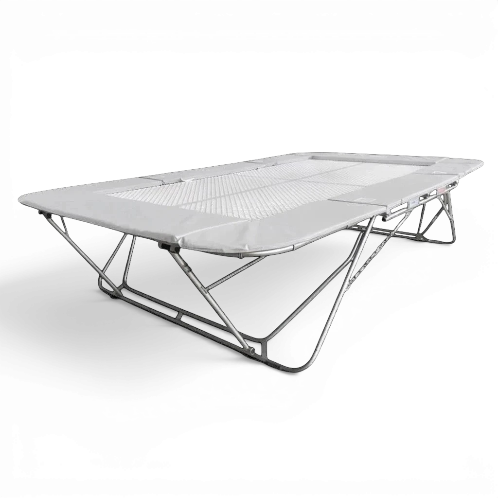 UK Gym Pits 77a standard competition trampoline with a white super-mesh bed and grey protective frame pads.