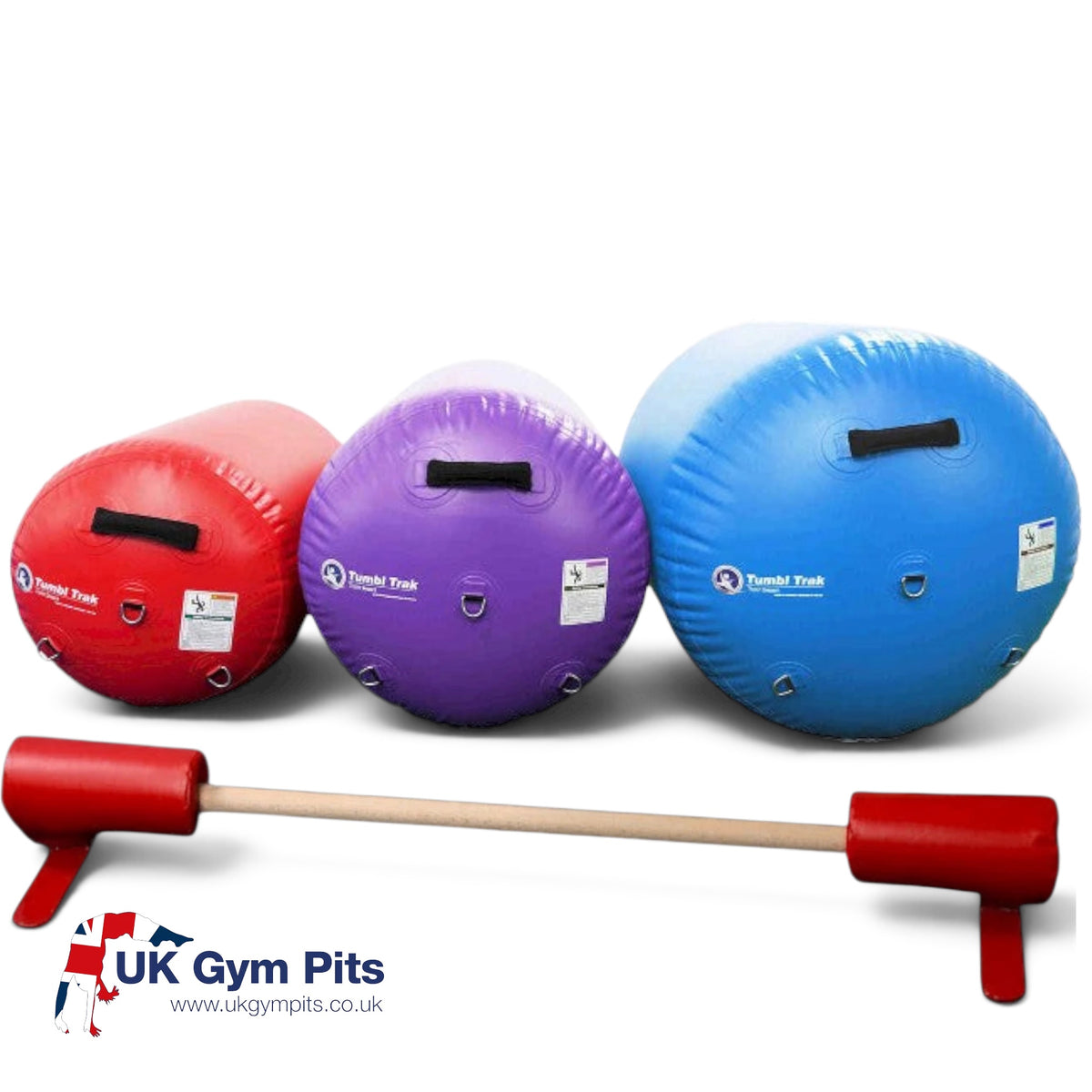 UK Gym Pits air barrels in red, purple, and blue with a wooden floor bar for gymnastics training.