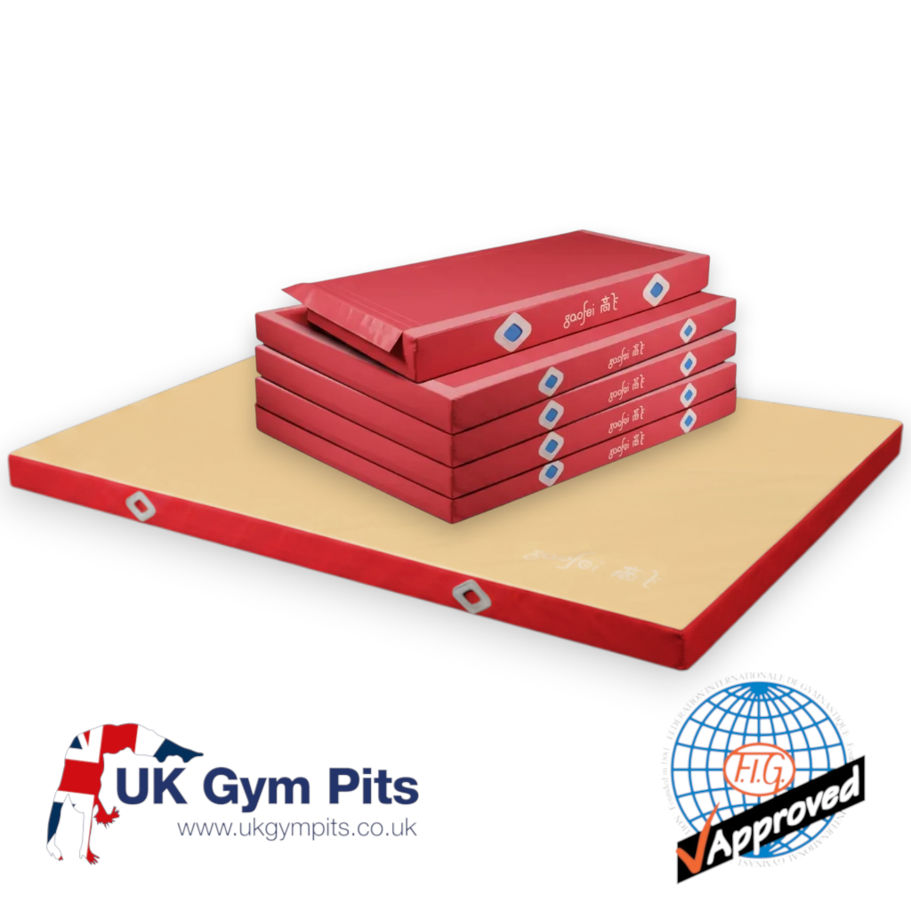 UK Gym Pits FIG approved asymmetric bars landing mats with red base units and a beige soft topper for gymnastics.