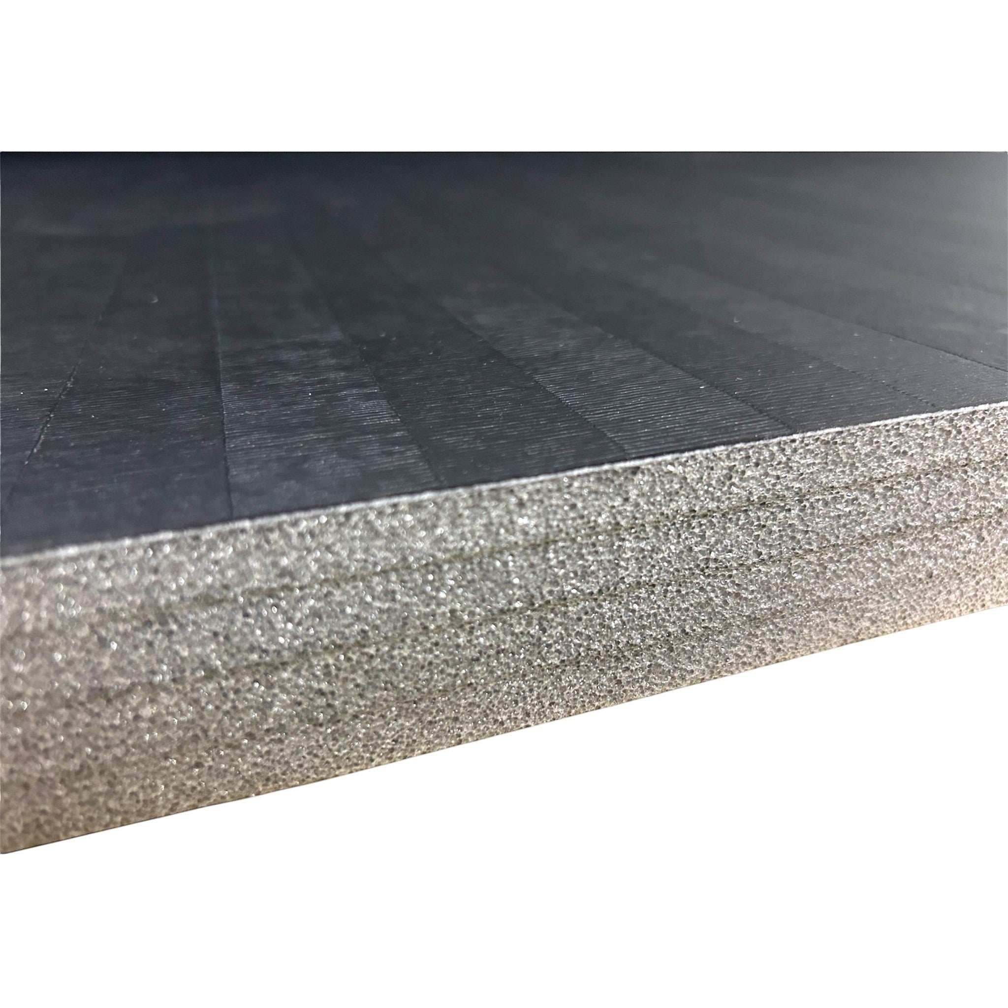UK Gym Pits black hybrid mat roll showing the textured tatami-style PVC surface and dense cross-linked XPE foam core.