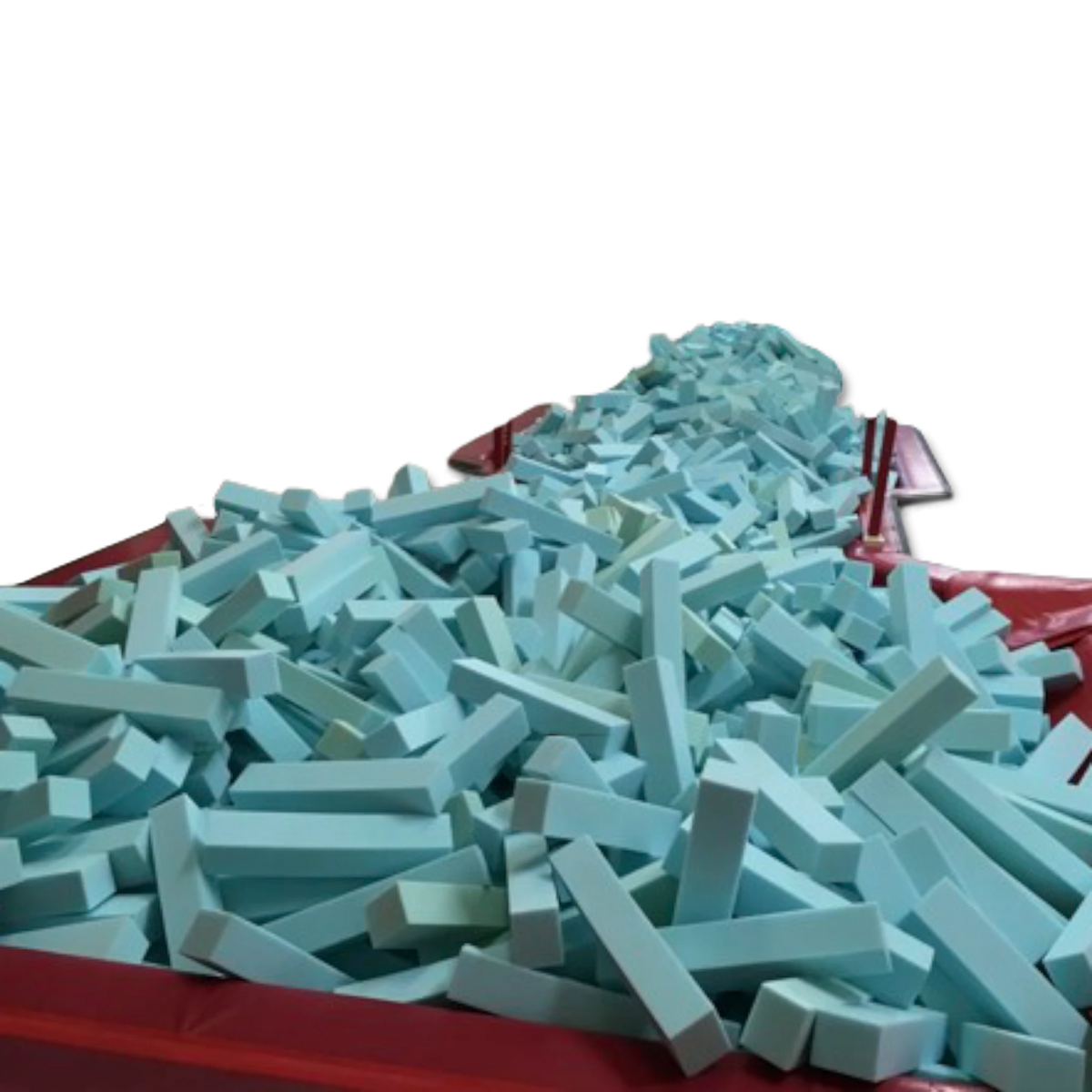UK Gym Pits light blue foam logs filling a gymnastics landing pit with a red padded border against a black background