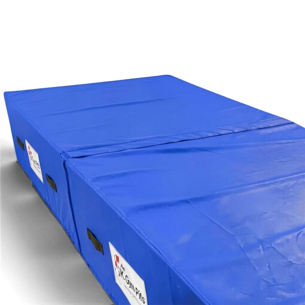 UK Gym Pits blue high-density foam track run-up block with reinforced PVC cover and carry handles for gymnastics.