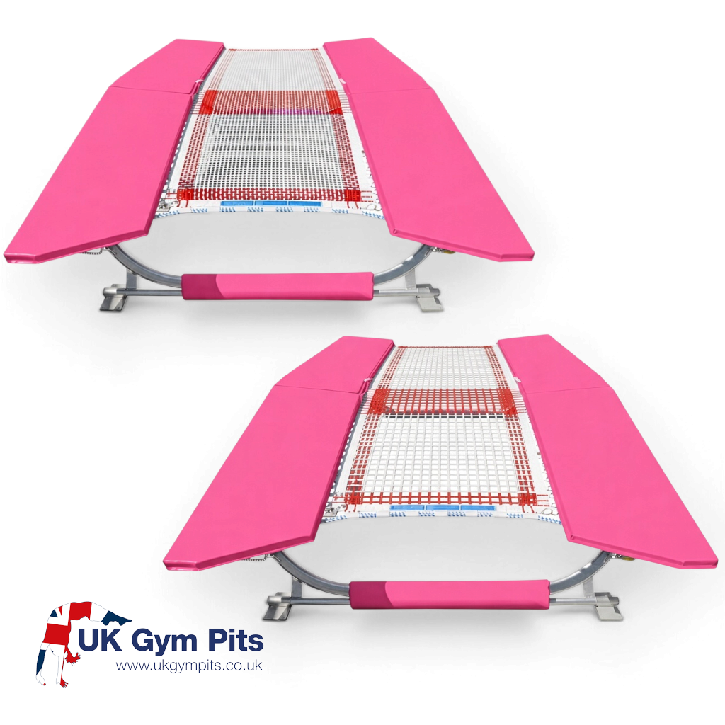 UK Gym Pits double mini tramp with pink frame pads and white web bed, built to FIG specifications for gymnastics.