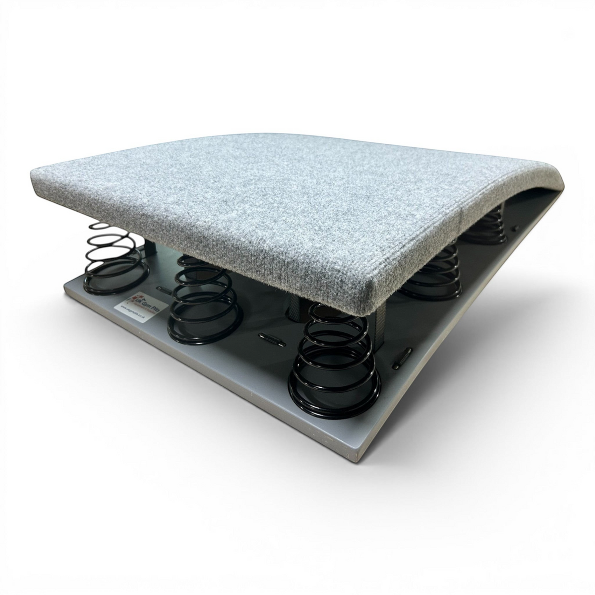 UK Gym Pits FIG approved gymnastics springboard with grey carpeted surface and black tapered steel springs