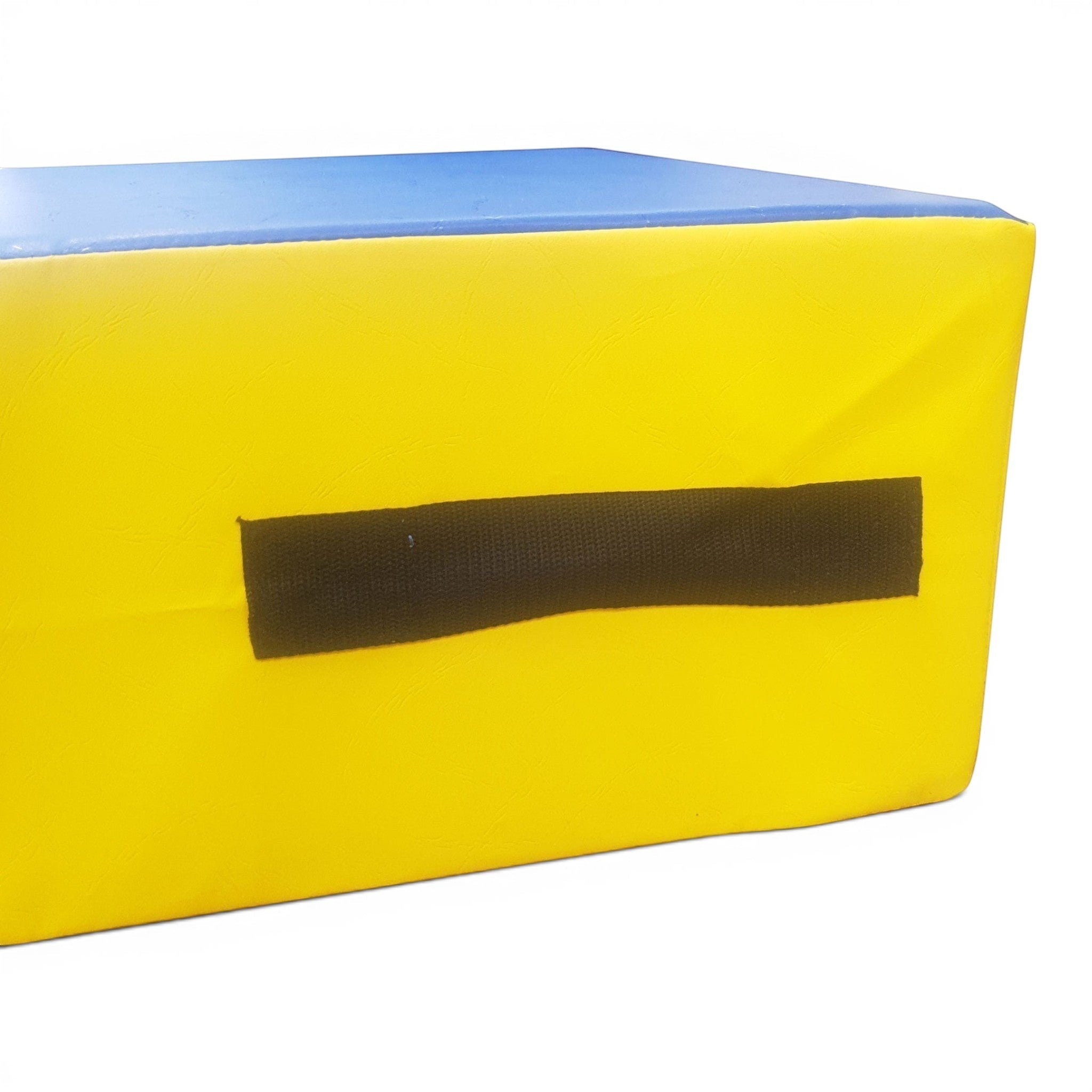 UK Gym Pits foam springboard with a yellow side, blue top, and black carry handle for gymnastics and soft play.