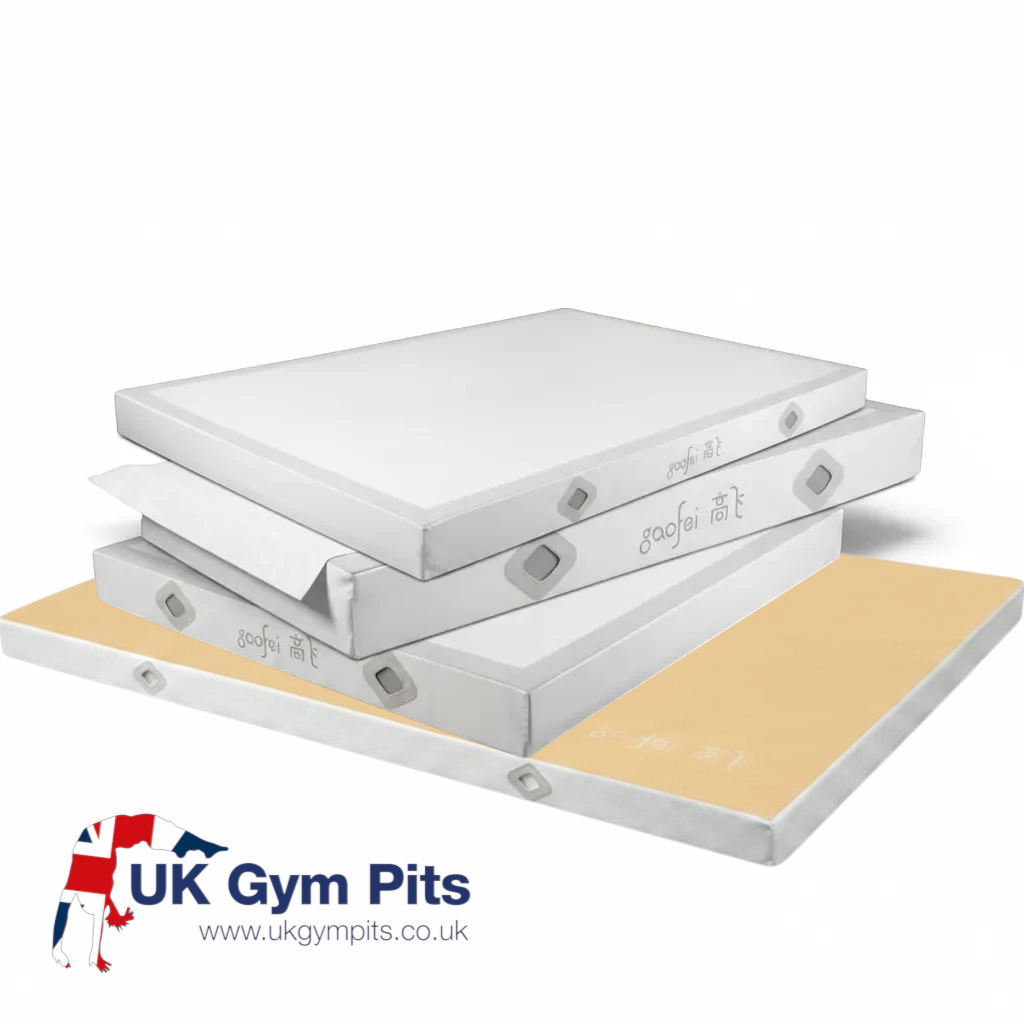 UK Gym Pits Gaofei gymnastics landing mats stacked, featuring durable PVC vinyl, air mesh windows, and a soft top layer.