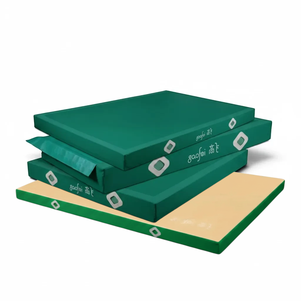 UK Gym Pits Gaofei green and beige gymnastics landing mats stacked for training and competition use
