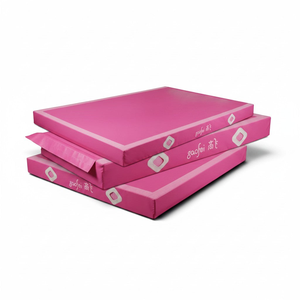 UK Gym Pits Gaofei pink gymnastics landing mats stacked, featuring durable PVC vinyl and air distribution mesh.