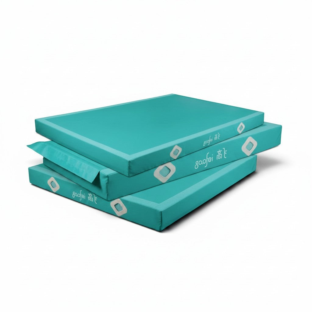 UK Gym Pits Gaofei teal gymnastics landing mats stacked, featuring durable PVC vinyl and air distribution mesh.