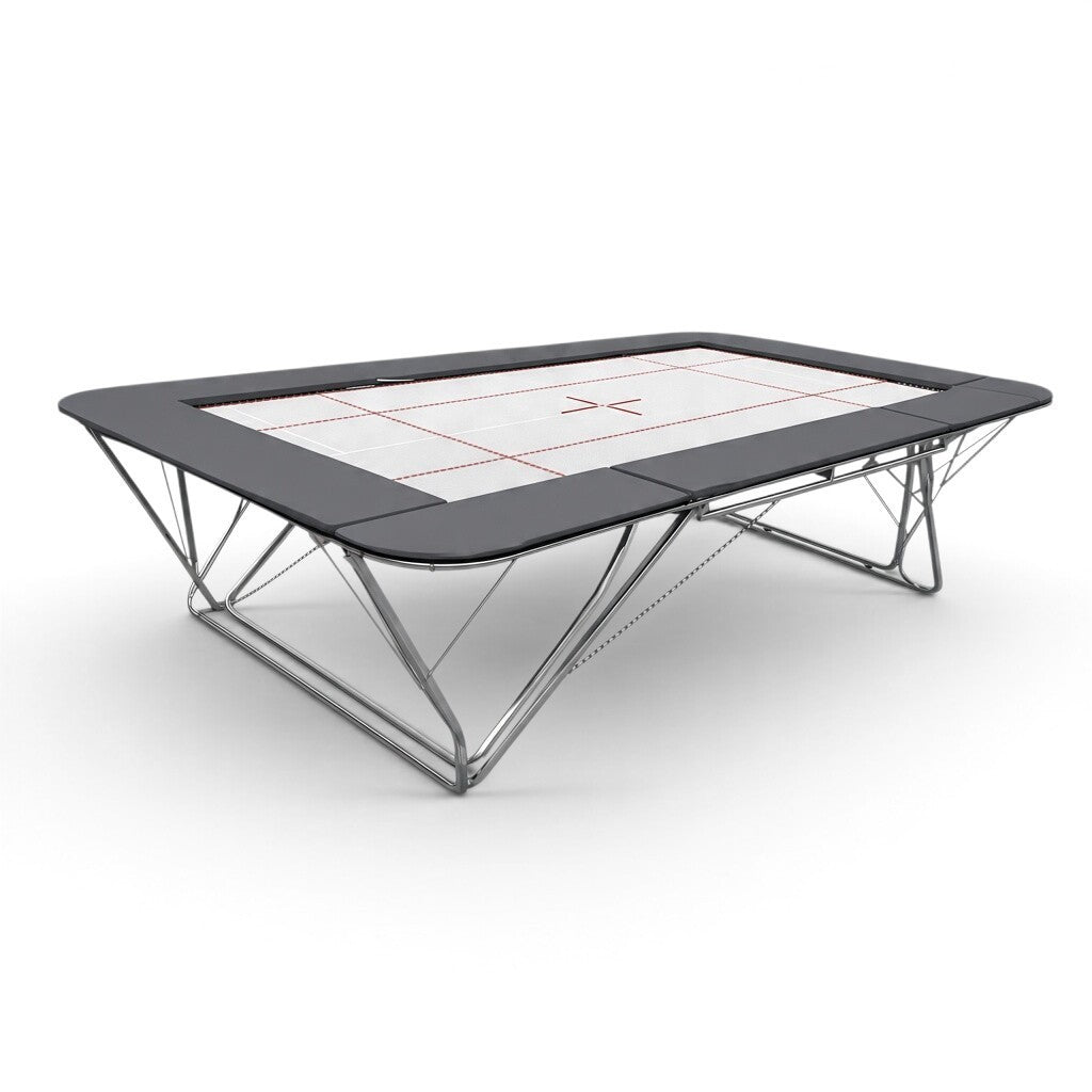 UK Gym Pits GM Extreme competition trampoline with a 6mm web bed, FIG markings, and black protective frame pads.
