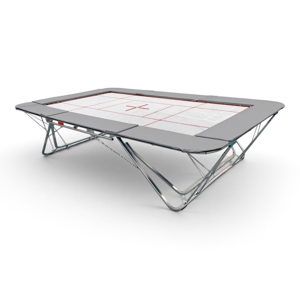 UK Gym Pits GMEX Extreme competition trampoline with a white web bed, grey frame pads, and steel spring frame.