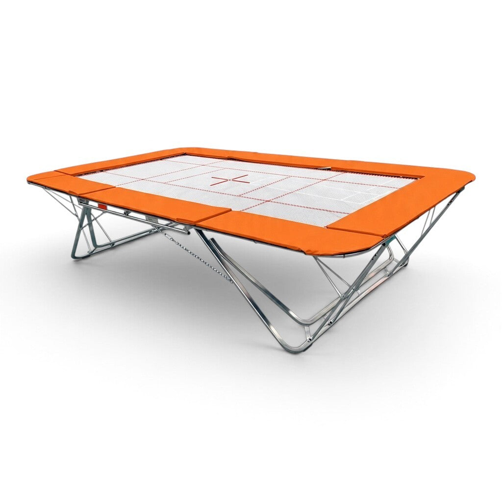 UK Gym Pits GMEX Extreme competition trampoline with a white web bed and bright orange protective frame pads.