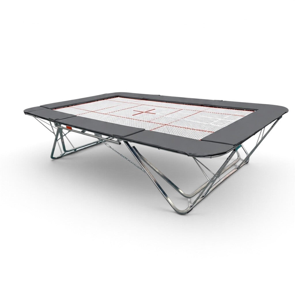 UK Gym Pits GMEX Extreme competition trampoline with a white web bed and grey protective frame pads on a white background
