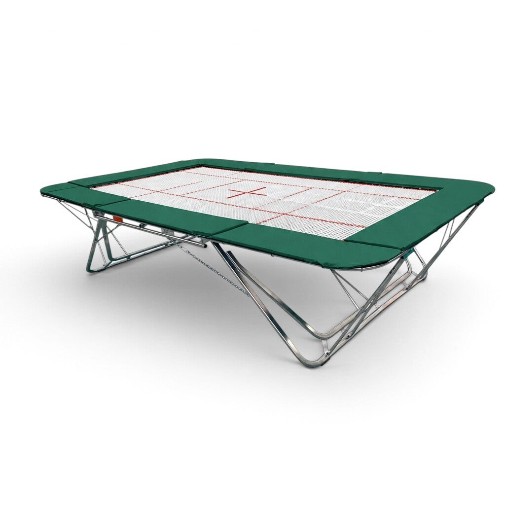 UK Gym Pits GMEX Extreme competition trampoline with a white web bed and green protective frame pads