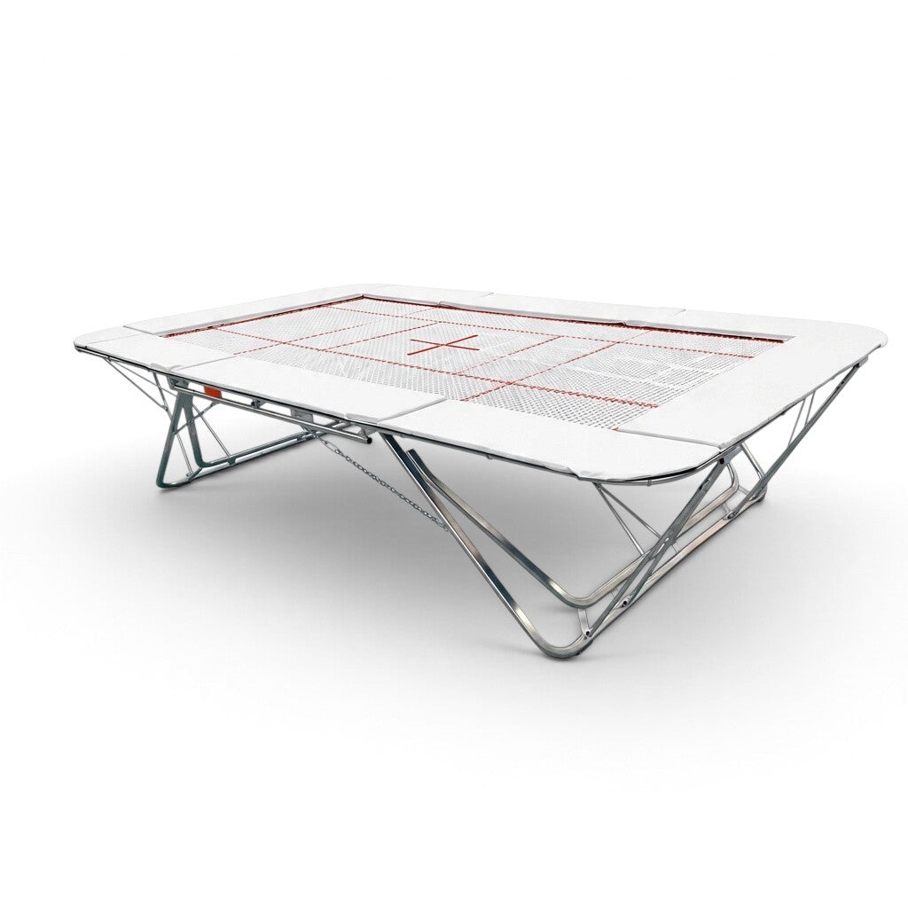 UK Gym Pits GMEX Extreme competition trampoline with a white web bed and protective frame pads on a steel frame.
