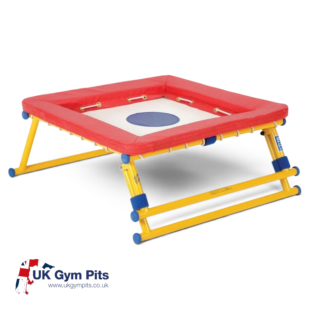 UK Gym Pits Gym Time Bouncer with a white jumping bed, red foam padding, and a yellow powder-coated steel frame.