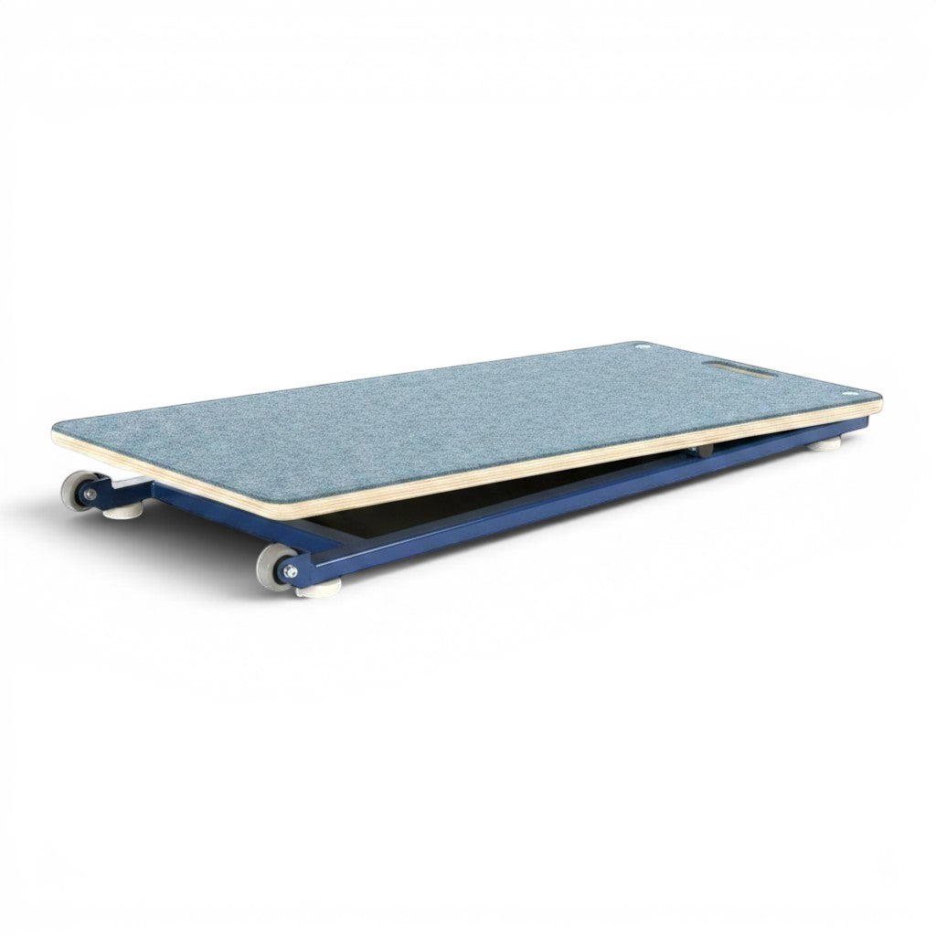 UK Gym Pits junior gymnastics springboard with blue carpeted birch ply deck and powder coated steel frame with wheels