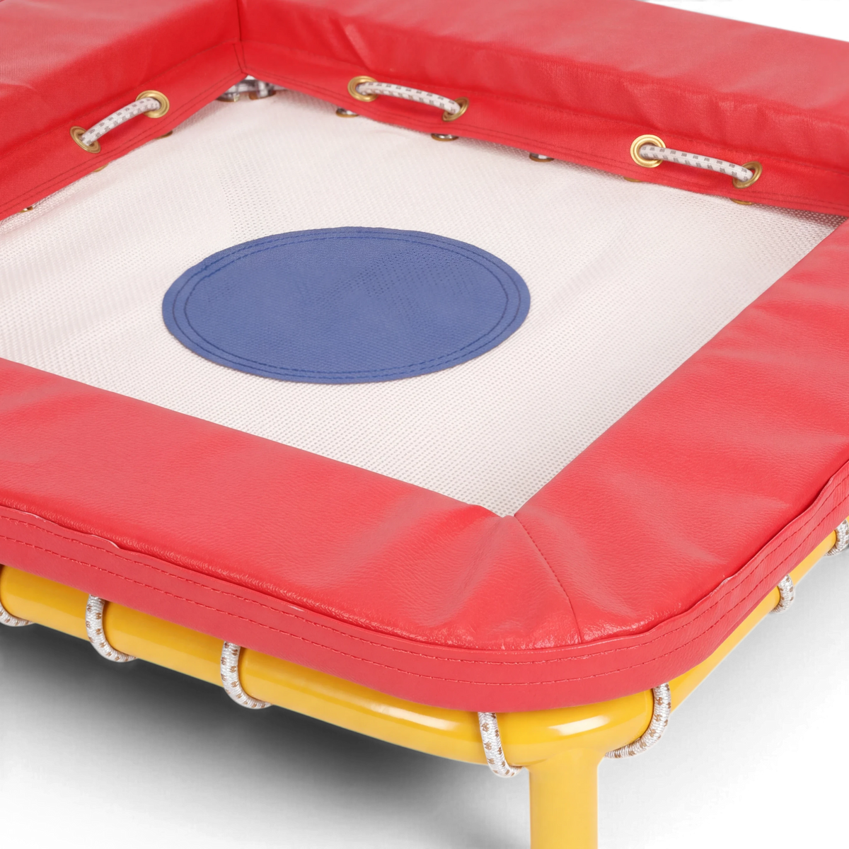 UK Gym Pits Activ Bounce mini trampette with a white bed, blue center target, red foam padding, and yellow frame.
