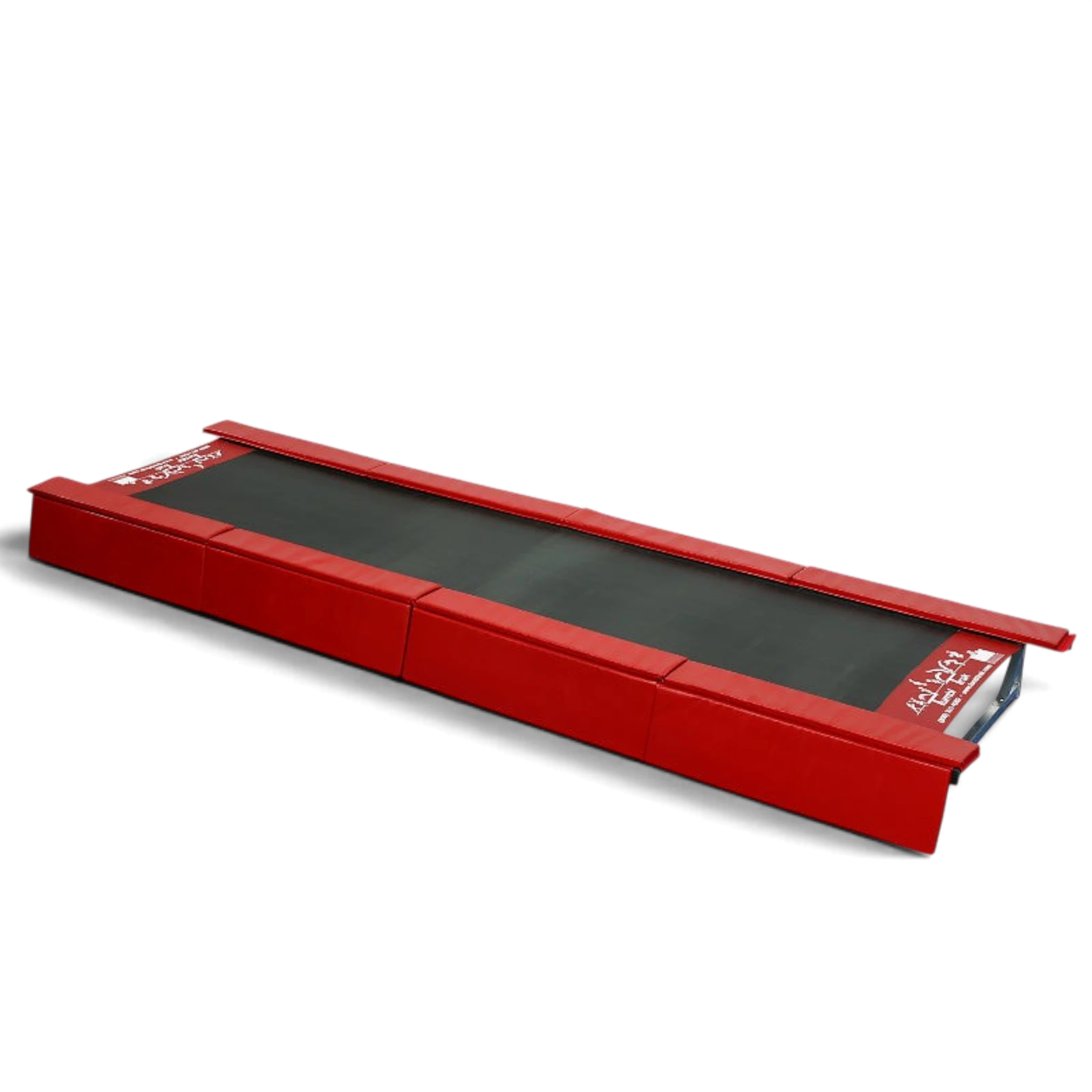 UK Gym Pits padded red vinyl safety skirts attached to the sides of a Tumbl Trak gymnastics training track