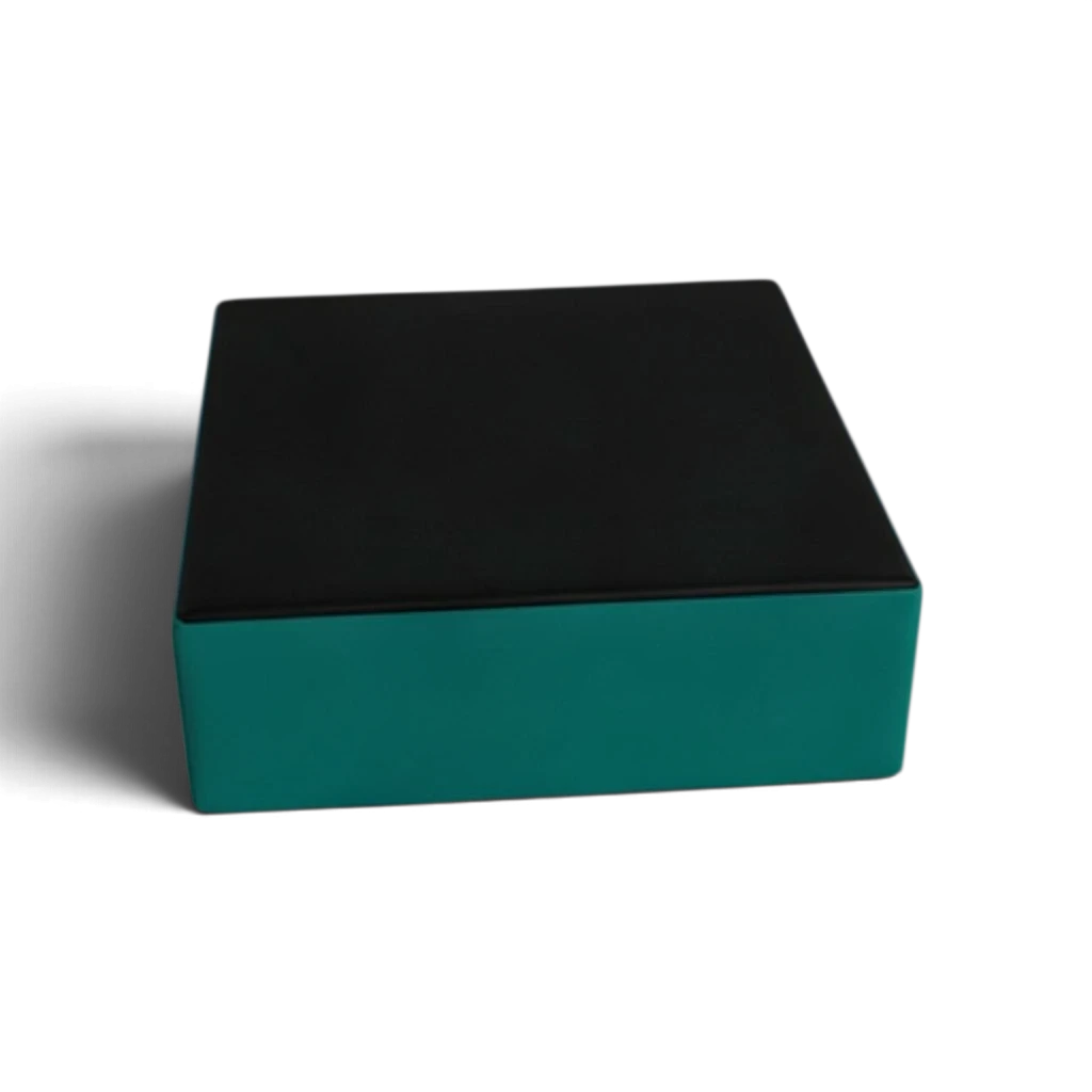 UK Gym Pits parkour stepping block with a black top and teal sides made from durable flame-retardant PVC foam.