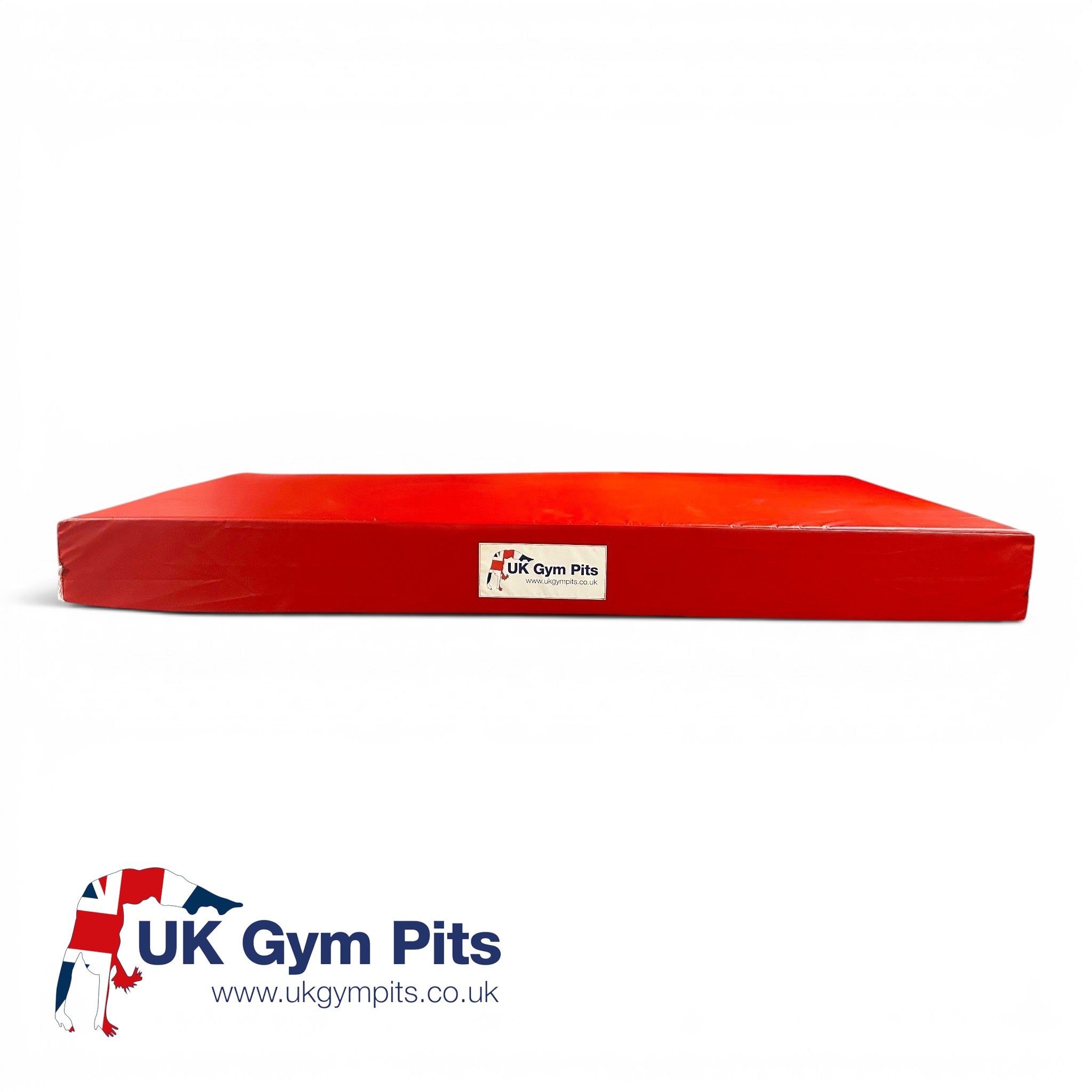 UK Gym Pits red crash mat for gymnastics and martial arts with shock-absorbing foam and heavy-duty PVC cover.