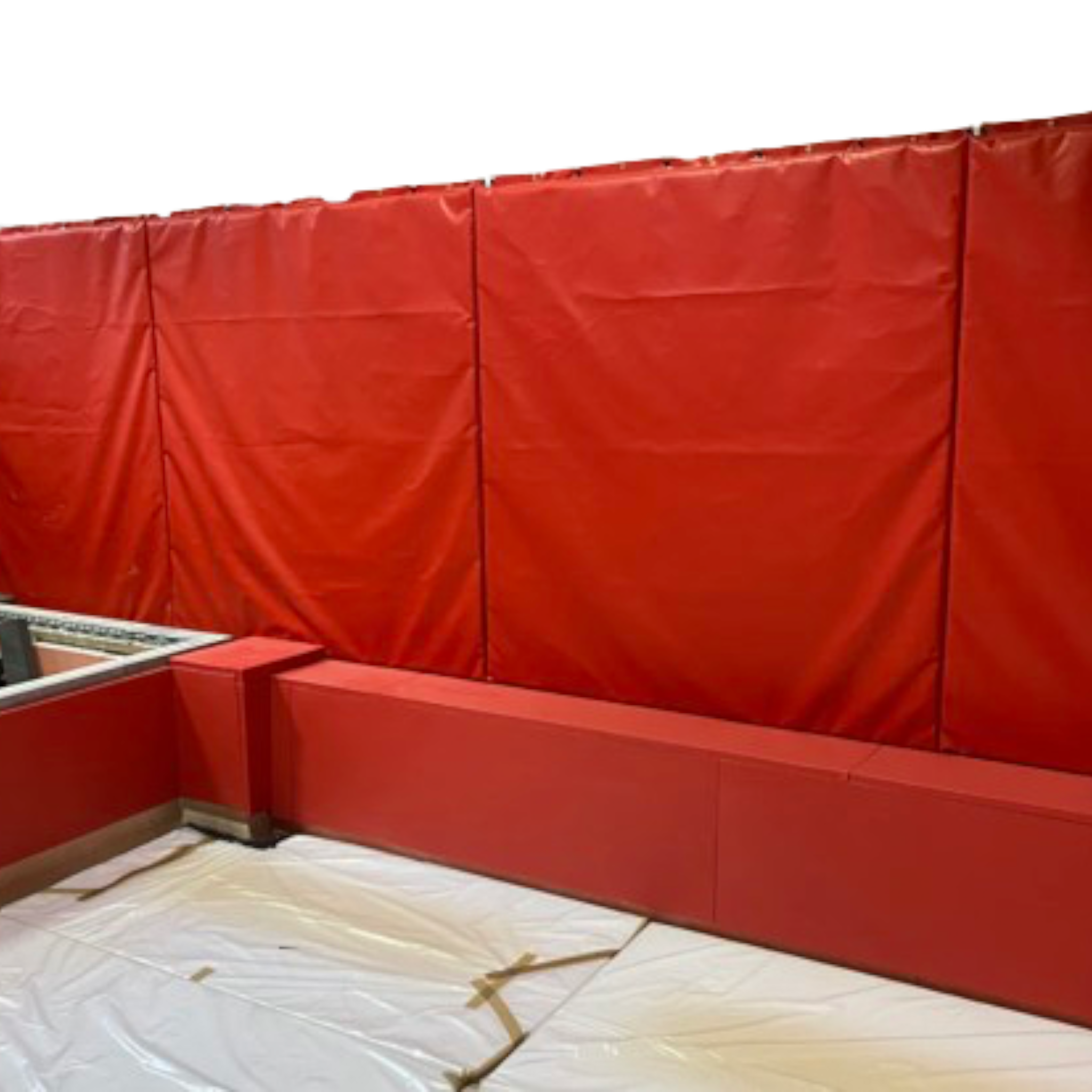 UK Gym Pits red PVC foam wall and top edge padding installed in a gymnastics landing pit area.