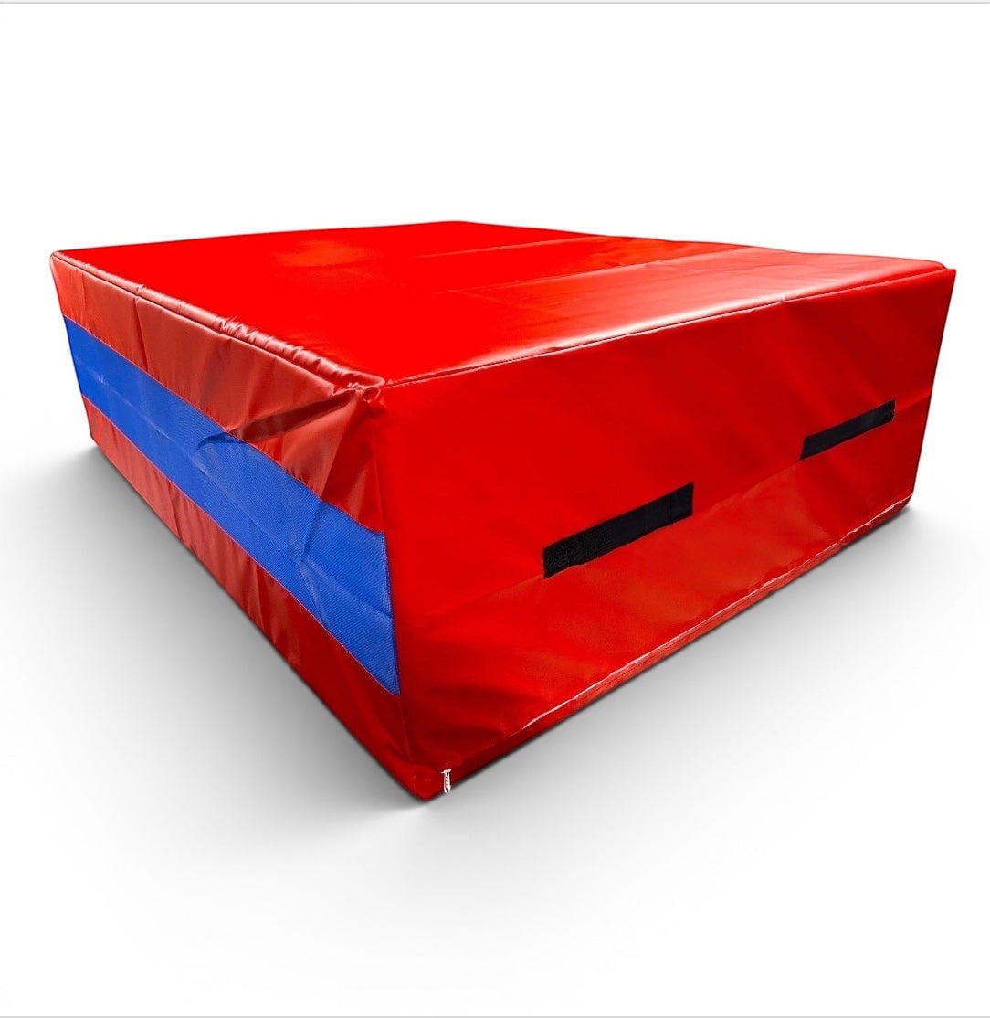 UK Gym Pits red and blue shock-absorbing resi foam landing pit for gymnastics and parkour with heavy-duty handles.