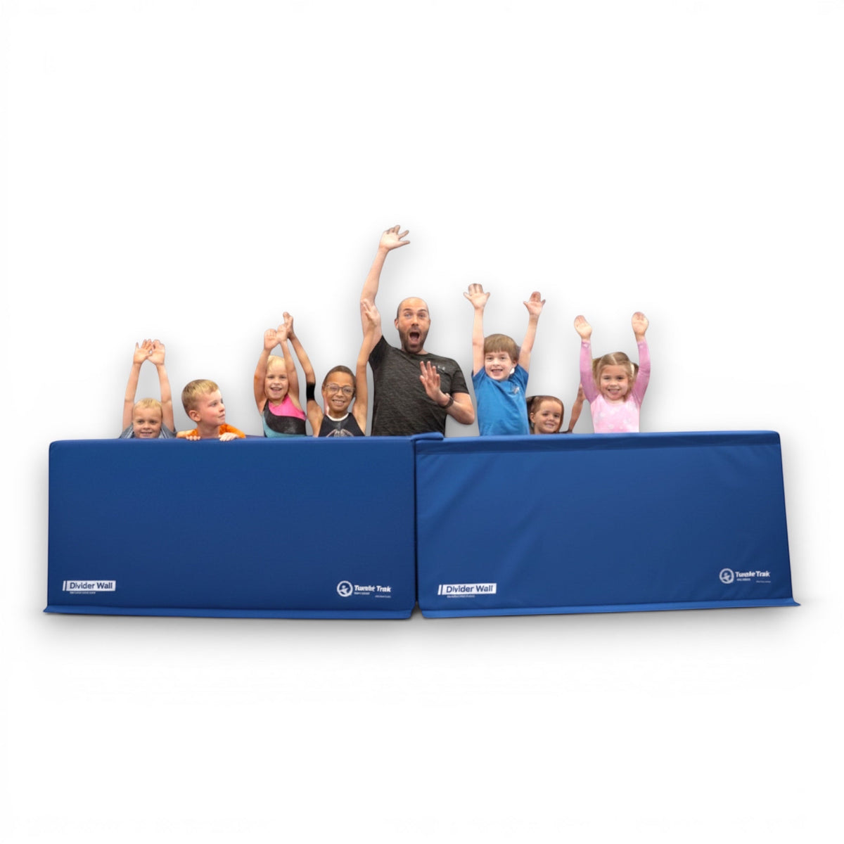 UK Gym Pits royal blue foam divider walls with a group of children and an instructor waving behind them