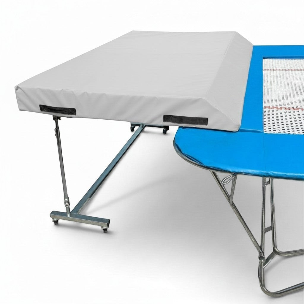 UK Gym Pits international spotting end deck with grey wedged safety mat attached to a blue trampoline frame