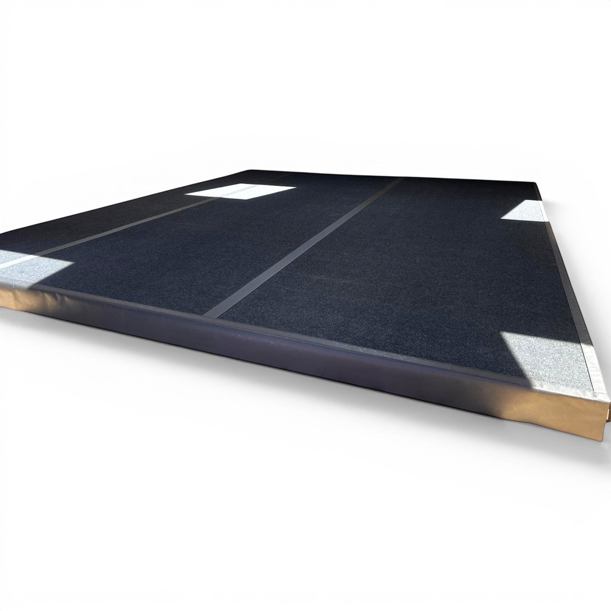 UK Gym Pits black PVC side skirt attached to a carpeted gymnastics sprung floor with Velcro overflap