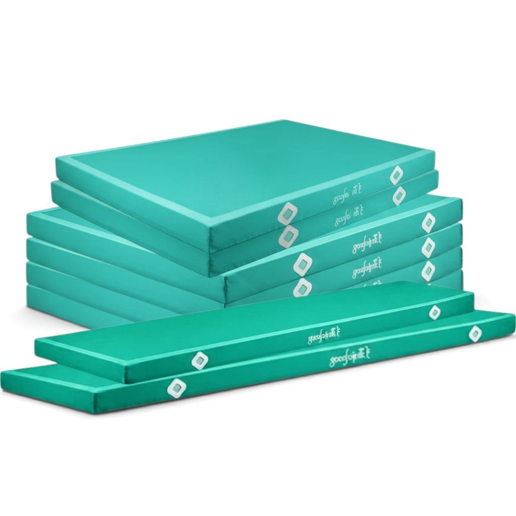 UK Gym Pits Gaofei teal gymnastics landing mats stacked, featuring durable PVC vinyl and Velcro locking system.