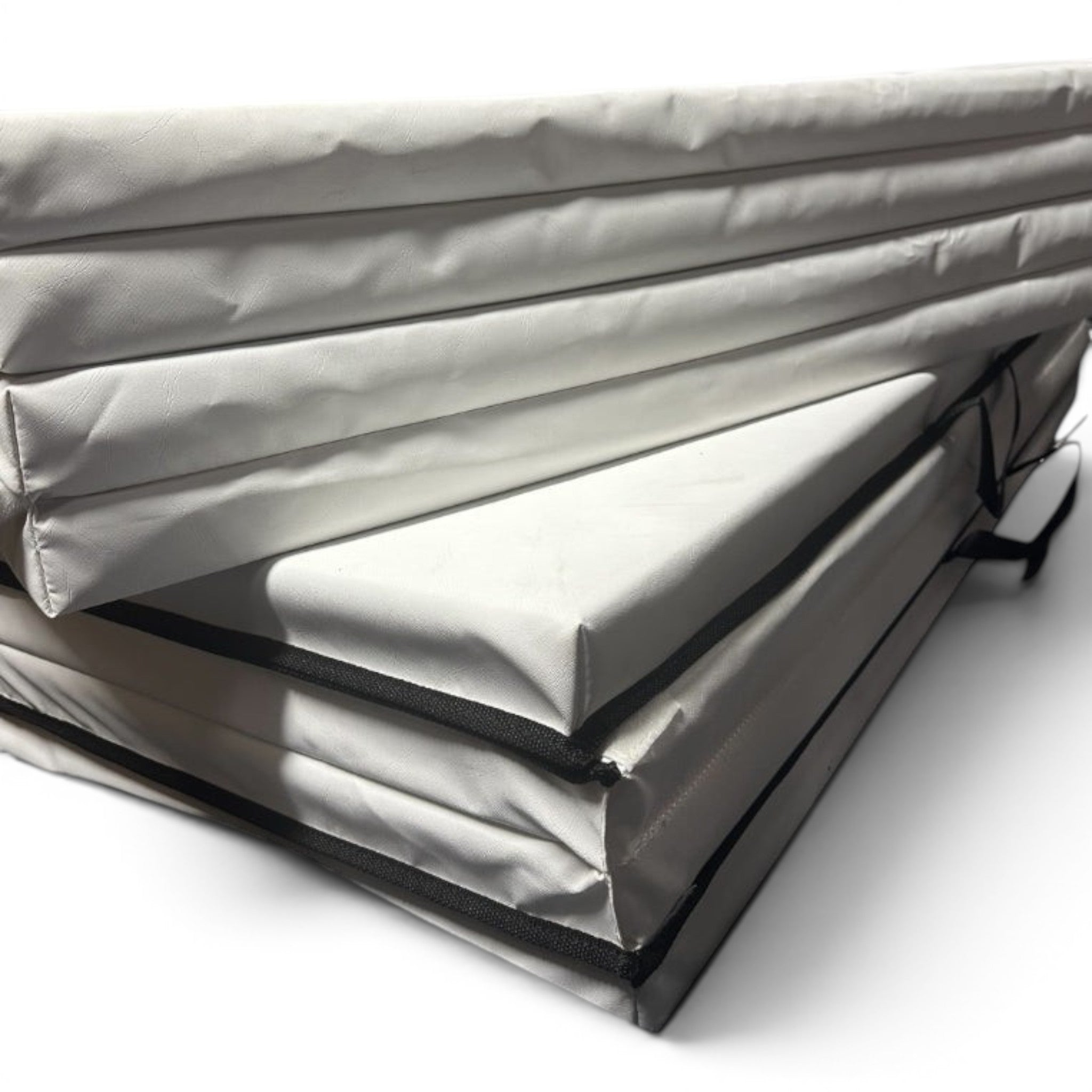 UK Gym Pits white foldable gymnastics mat made of durable PVC with a carry handle for easy transport and storage.