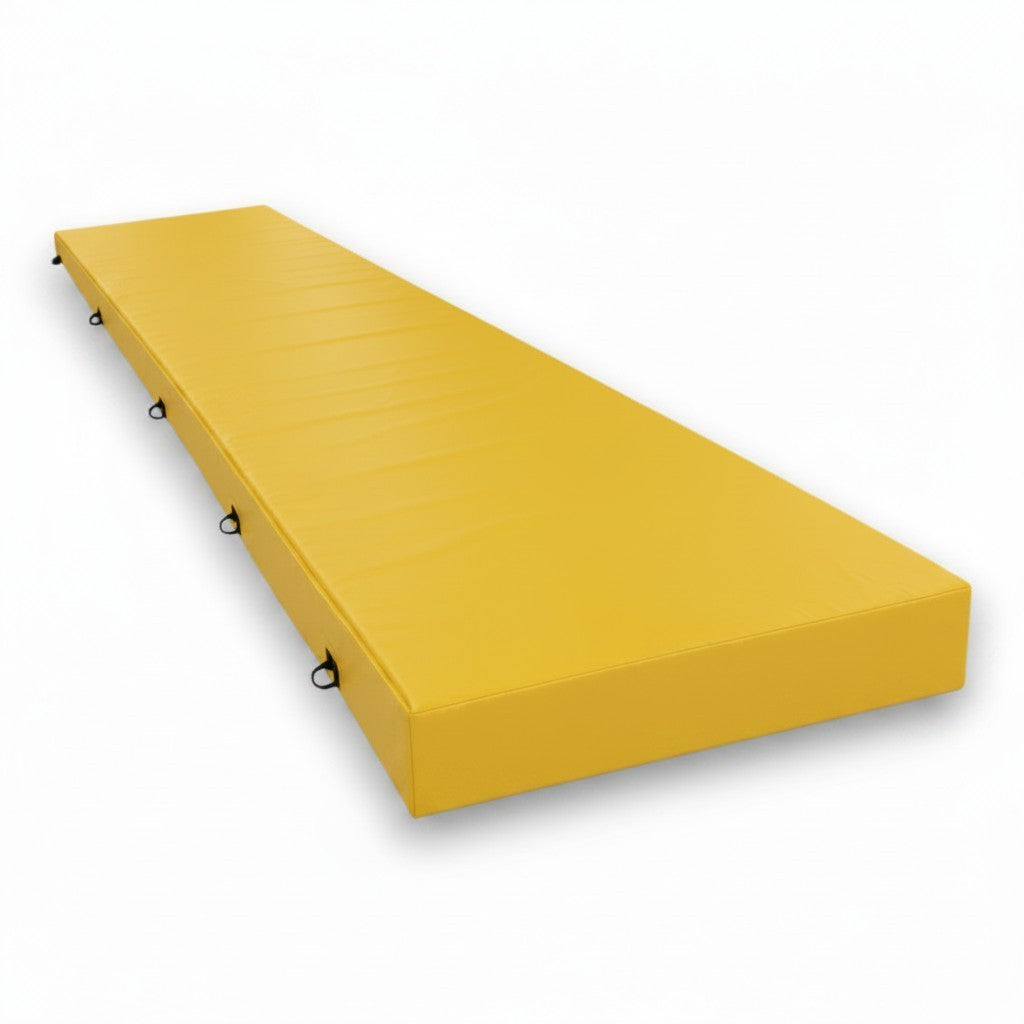 UK Gym Pits yellow PVC splat mat with shock-absorbing foam and side handles for gymnastics and martial arts training.