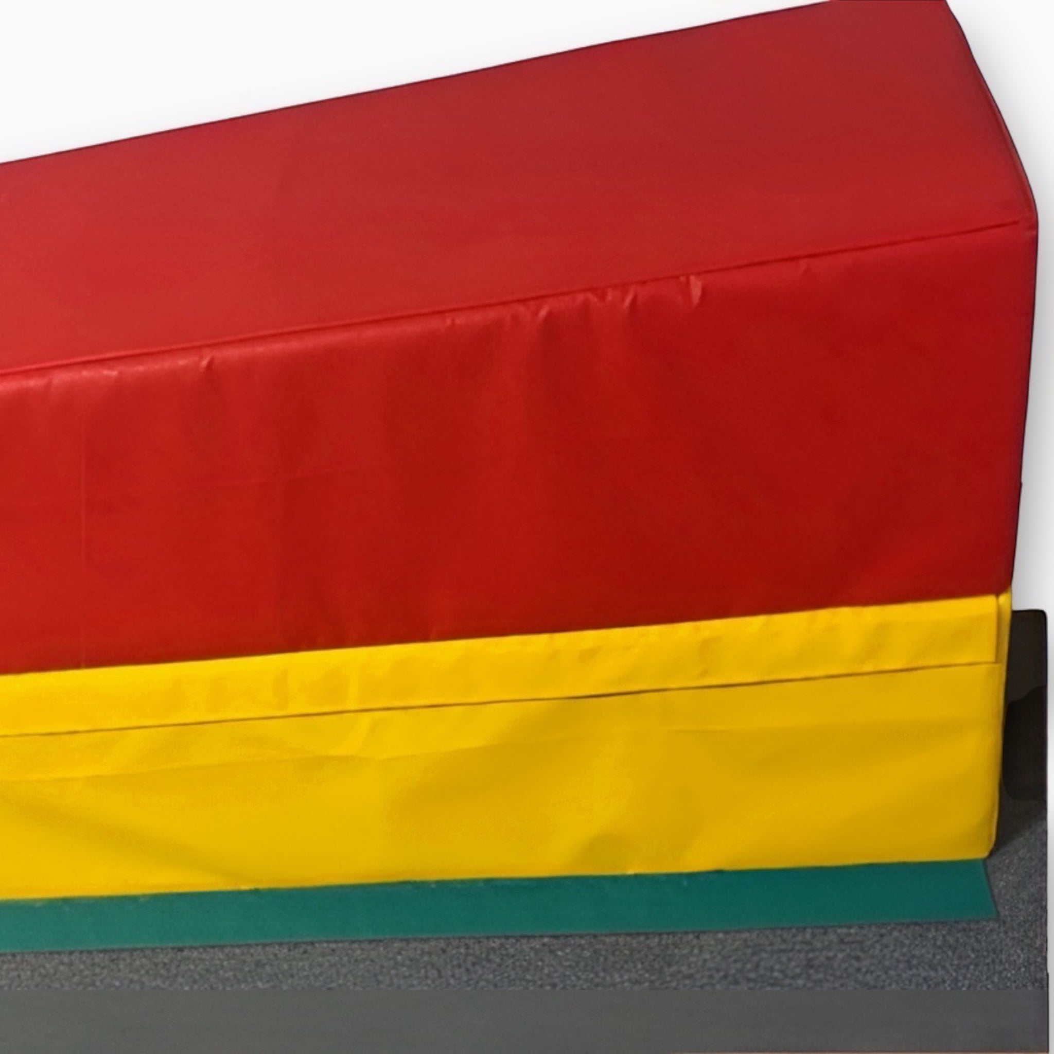 UK Gym Pits 4 tiered foam vault box for gymnastics training, featuring red, yellow, and green PVC sections.
