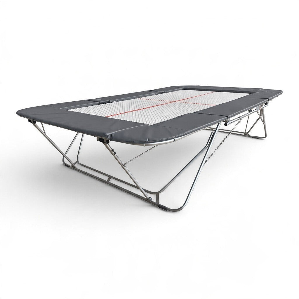 UK Gym Pits 77a standard competition trampoline with a 25mm web bed and grey protective frame pads.