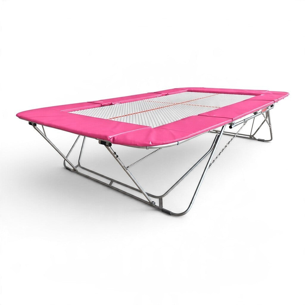 UK Gym Pits 77a standard competition trampoline with a white 25mm web bed and vibrant pink protective frame pads.