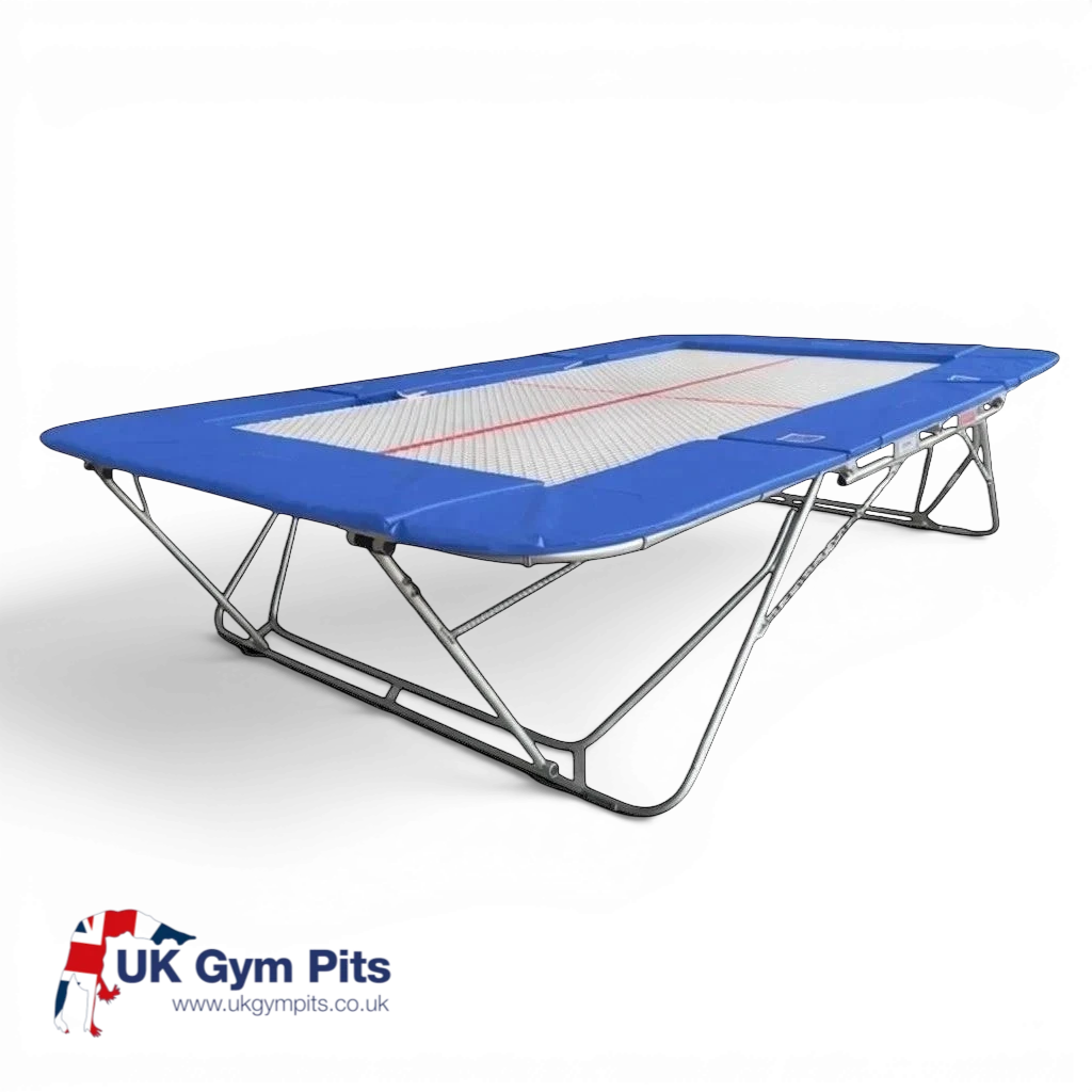 UK Gym Pits 77a standard competition trampoline with blue frame pads and a white super-mesh bed on a white background.