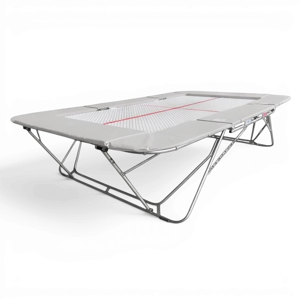 UK Gym Pits 77a standard competition trampoline with a 13mm web bed and grey protective frame pads on a black background.