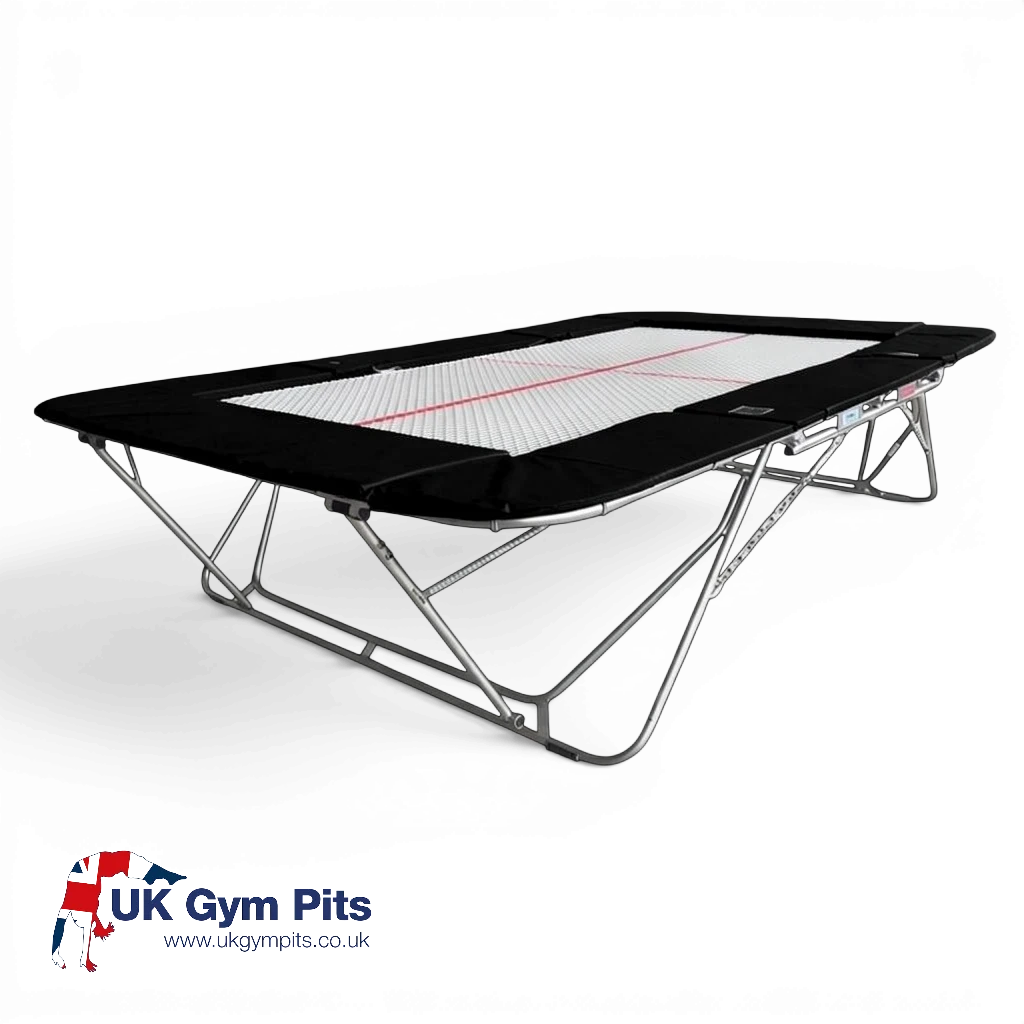 UK Gym Pits 77a standard competition trampoline with a 13mm white web bed and black protective frame pads.