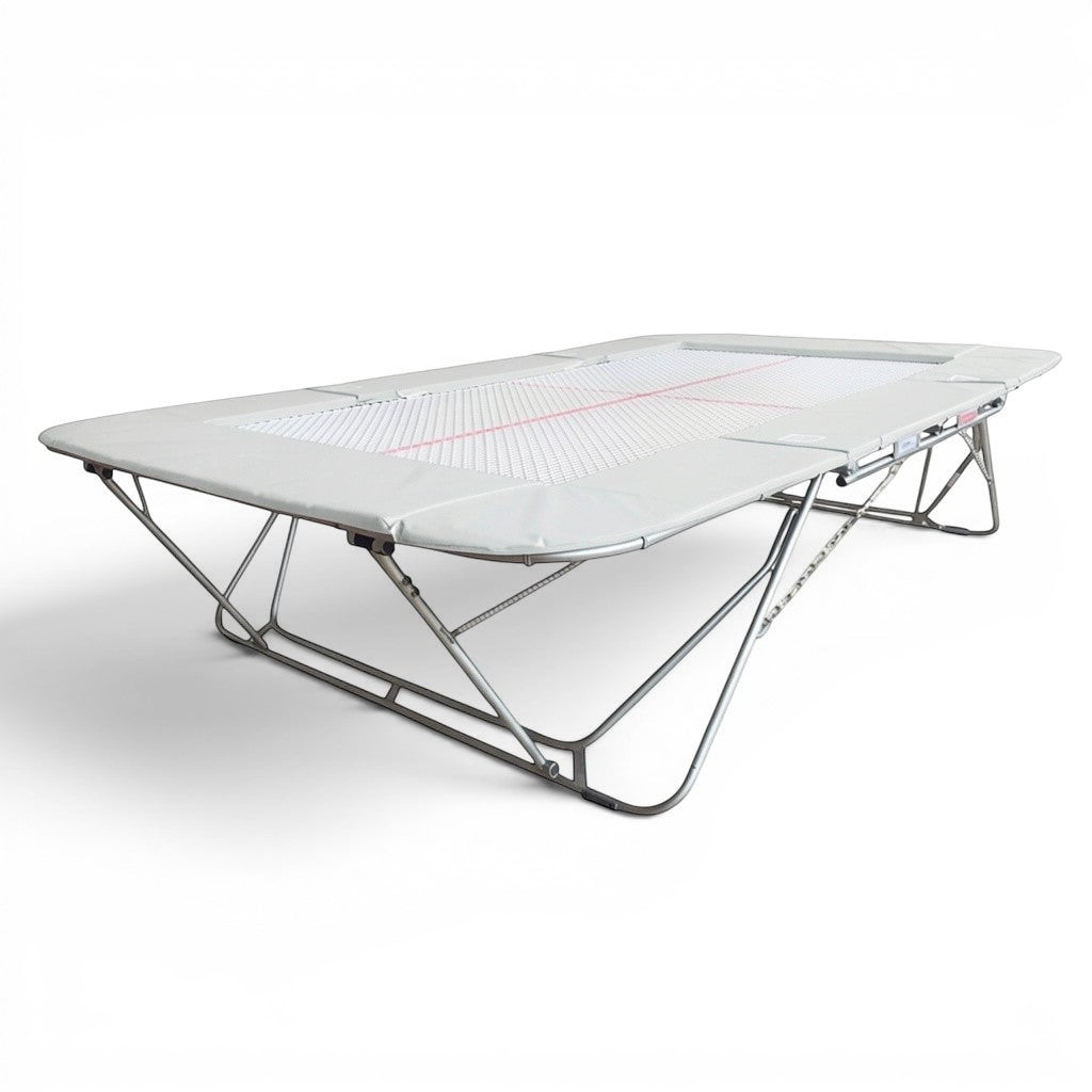 UK Gym Pits 77a standard trampoline with a 25mm web bed and grey protective frame pads for gymnastics training.