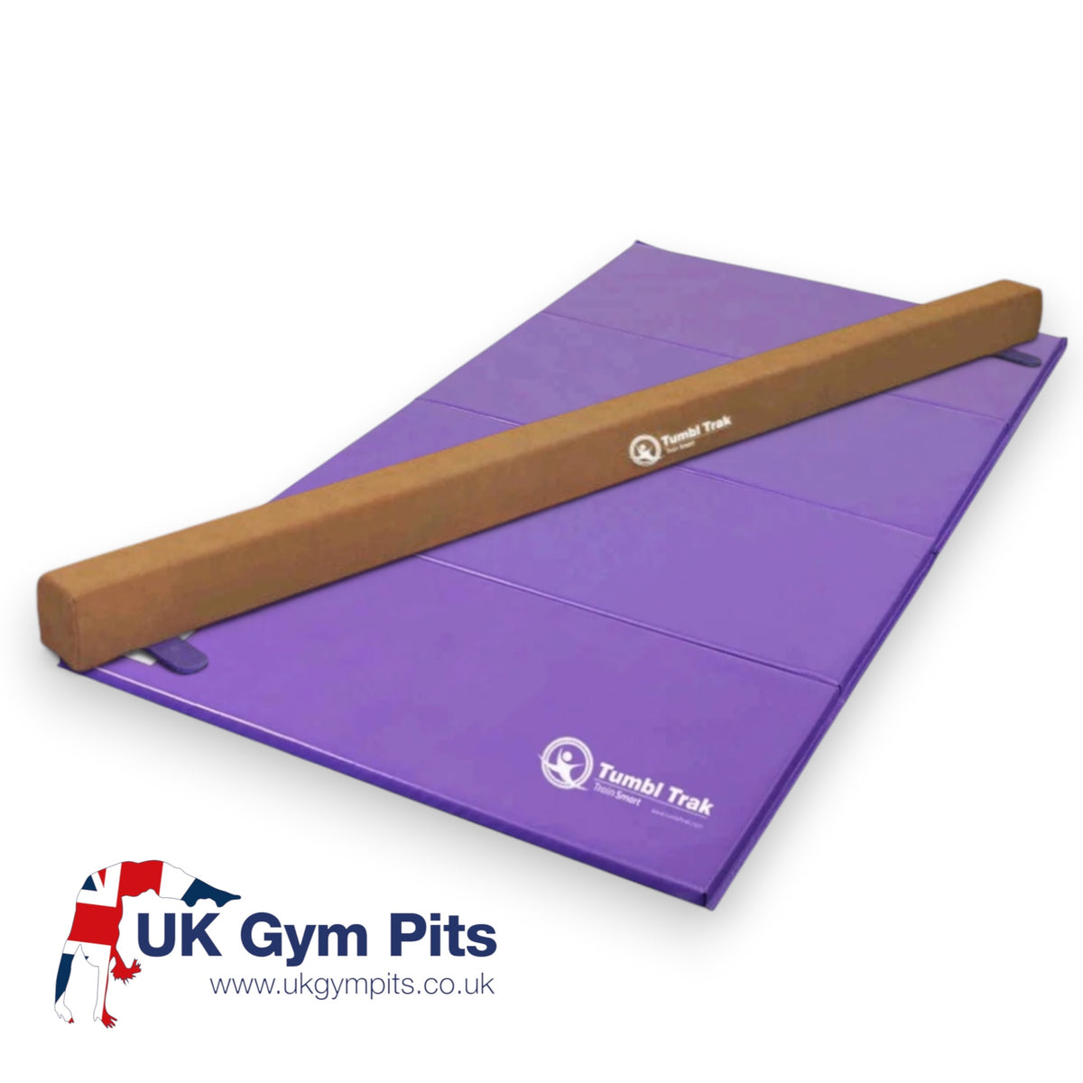 UK Gym Pits Addie beam in tan synthetic suede placed on a purple folding tumbling mat for gymnastics training
