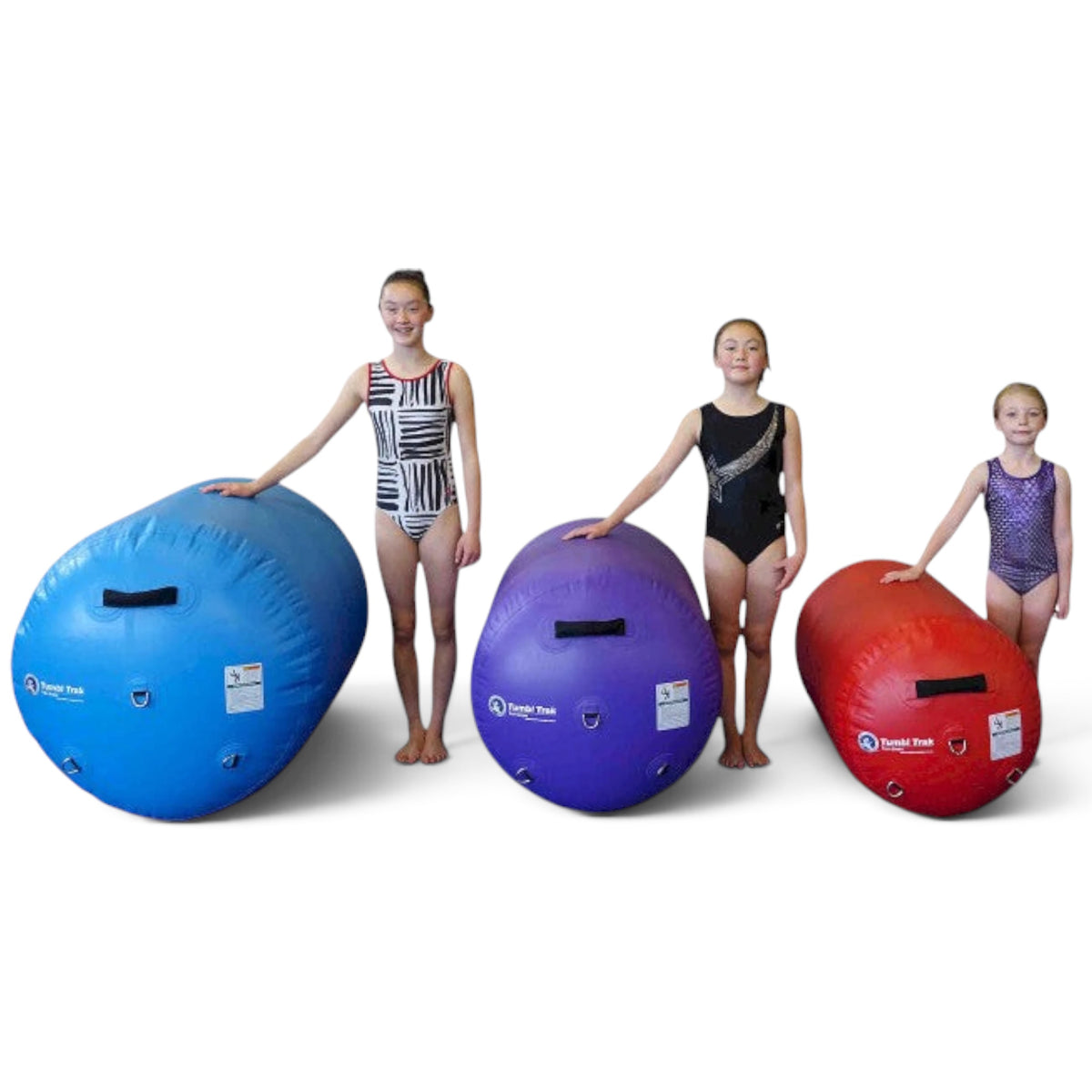 UK Gym Pits air barrels in sky blue, purple, and red with young gymnasts standing beside each size for scale