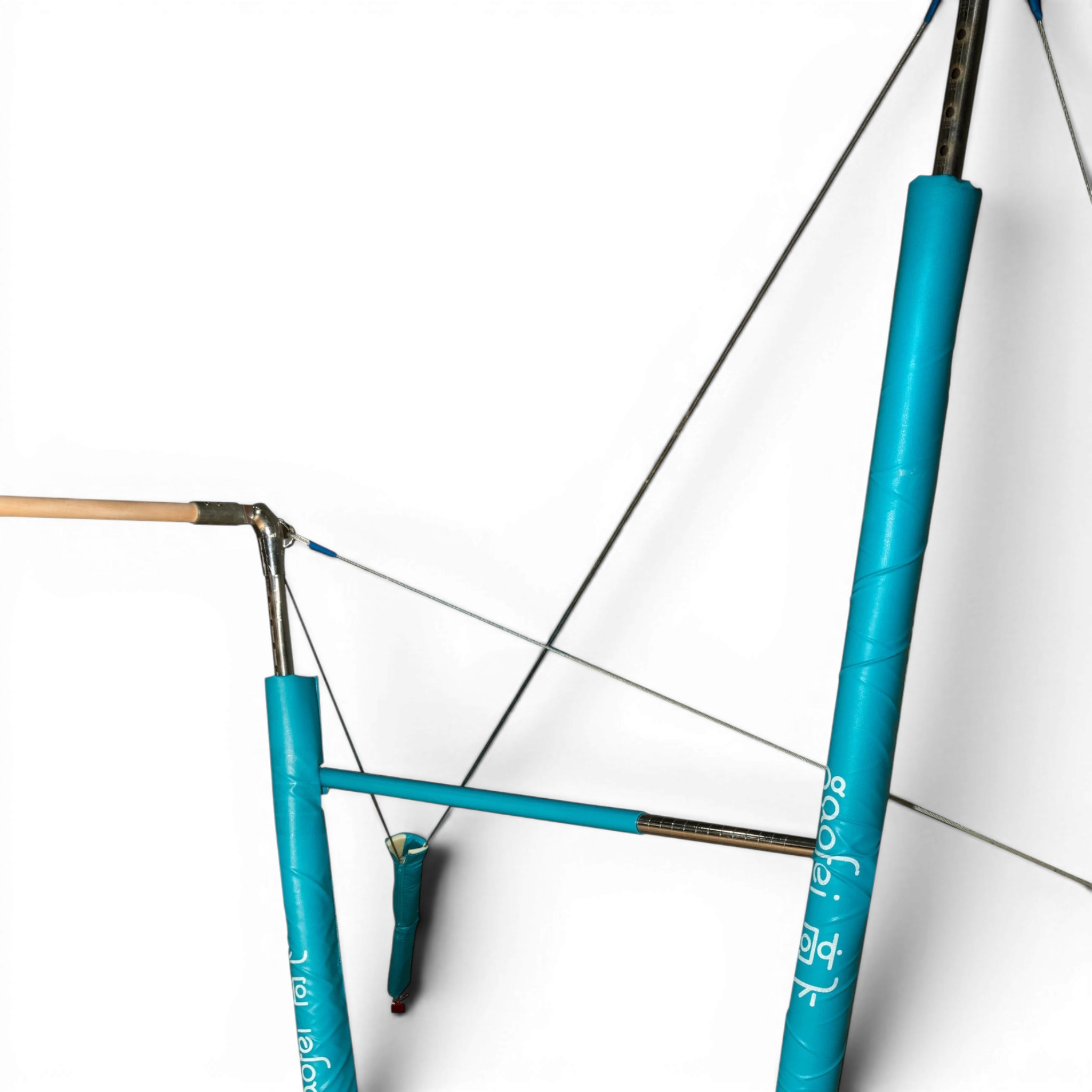 UK Gym Pits FIG approved asymmetric bars with wooden handrails, blue protective padding, and steel support cables.